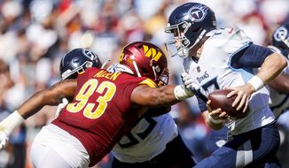 Washington Commanders defensive tackle Jonathan Allen (93) pressures Tennessee Titans quarterback Ryan Tannehill (17) during the first half of an NFL football game Sunday, Oct. 9, 2022 in Landover, Va. (Shaban Athuman/Richmond Times-Dispatch via AP)