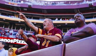 Washington Commanders fans react after their team was intercepted in the last seconds of an NFL football game against the Tennessee Titans on Sunday, Oct. 9, 2022, in Landover, Md. (Shaban Athuman/Richmond Times-Dispatch via AP) **FILE**
