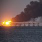 Flame and smoke rise fron Crimean Bridge connecting Russian mainland and Crimean peninsula over the Kerch Strait, in Kerch, Crimea, Saturday, Oct. 8, 2022. Russian authorities say a truck bomb has caused a fire and the partial collapse of a bridge linking Russia-annexed Crimea with Russia. Three people have been killed. The bridge is a key supply artery for Moscow&#x27;s faltering war effort in southern Ukraine. (AP Photo)