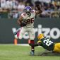 New York Giants running back Saquon Barkley (26) breaks away from Green Bay Packers safety Darnell Savage (26) for a touchdown during the second half of an NFL football game at the Tottenham Hotspur stadium in London, Sunday, Oct. 9, 2022. (AP Photo/Alastair Grant)