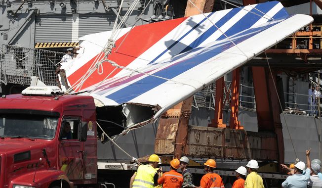 FILE - Workers unload debris, belonging to the crashed Air France flight AF447, from the Brazilian Navy&#x27;s Constitution Frigate in the port of Recife, northeast of Brazil, June 14, 2009. It was the worst plane crash in Air France history, killing people of 33 nationalities and having lasting impact. It led to changes in air safety regulations, how pilots are trained and the use of airspeed sensors. (AP Photo/Eraldo Peres, File)
