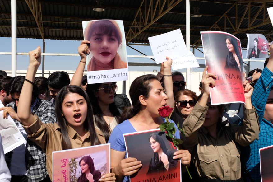 FILE - Protesters gather outside the UN headquarters in Erbil on Sept. 24, 2022, to protest the death of Masha Amini, who had fallen into a coma for three days after being detained by the morality police in Tehran, Iran. Spontaneous mass gatherings to persistent scattered demonstrations have unfolded in Iran, as nationwide protests over the death of a young woman in the custody of the morality police enter their fourth week. (AP Photo/Hawre Khalid, Metrography, File)