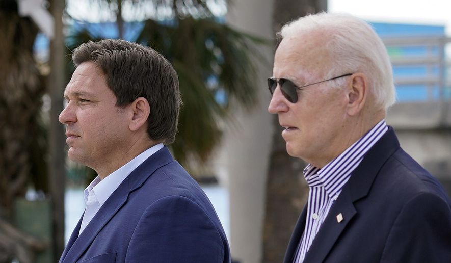 President Joe Biden and Florida Gov. Ron DeSantis arrive to tour an area impacted by Hurricane Ian on Wednesday, Oct. 5, 2022, in Fort Myers Beach, Fla. (AP Photo/Evan Vucci)