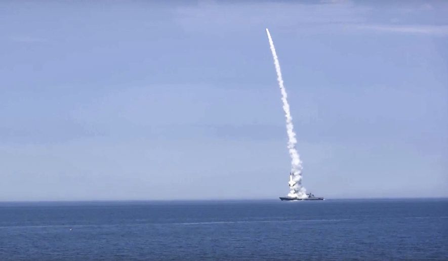 In this handout photo released by Russian Defense Ministry Press Service on Monday, Oct. 10, 2022, a Russian warship launches a cruise missile at a target in Ukraine. (Russian Defense Ministry Press Service via AP)