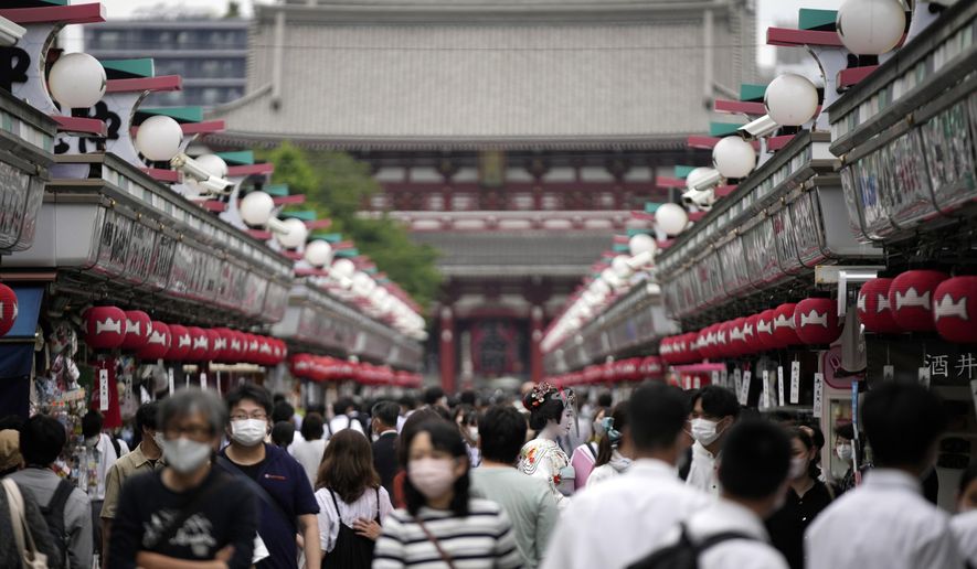 Visitors walk along a shopping street at the Asakusa district on June 10, 2022, in Tokyo. Individual travelers will be able to visit Japan without visas beginning Tuesday, Oct. 11, just like in pre-COVID-19 times. (AP Photo/Eugene Hoshiko, File)