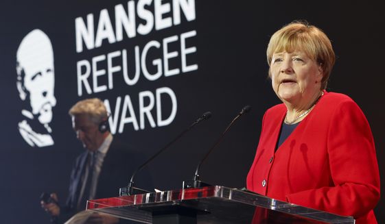 Angela Merkel speaks as she receives the UNHCR Nansen Refugee Award for protecting refugees at the height of the Syria crisis, during a ceremony in Geneva, Switzerland, Monday Oct. 10, 2022. (Stefan Wermuth/Pool via AP)