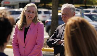 U.S. Rep. Abigail Spanberger, D-Va., left, speaks as U.S. Sen. Tim Kaine, D-Va., listens during a stop at an early voting center Tuesday, Oct. 11, 2022, in Stafford, Va. Spanberger is running against Republican Yesli Vega in November&#39;s 7th Congressional District race. (AP Photo/Steve Helber)