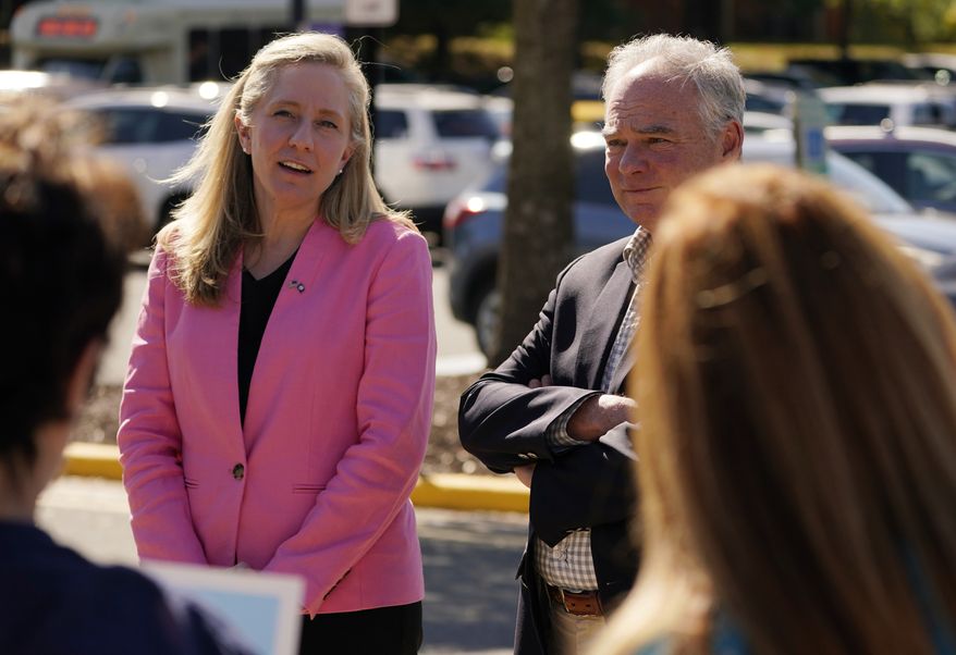 U.S. Rep. Abigail Spanberger, D-Va., left, speaks as U.S. Sen. Tim Kaine, D-Va., listens during a stop at an early voting center Tuesday, Oct. 11, 2022, in Stafford, Va. Spanberger is running against Republican Yesli Vega in November&#x27;s 7th Congressional District race. (AP Photo/Steve Helber)
