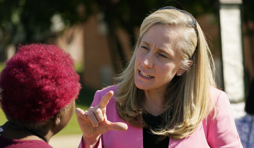 U.S. Rep Abigail Spanberger, D-Va., right, talks with a supporter at an early voting location, Tuesday, Oct. 11, 2022, in Stafford, Va. Spanberger is running against Republican Yesli Vega in November&#x27;s 7th Congressional District race. (AP Photo/Steve Helber)