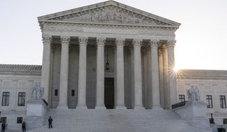 The sun rises behind the U.S. Supreme Court, Tuesday, Oct. 11, 2022, in Washington. (AP Photo/Alex Brandon) ** FILE **