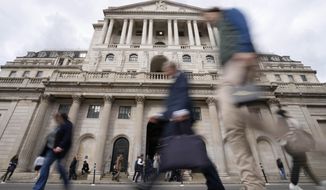 FILE - People pass the Bank of England in London, Wednesday, Sept. 28, 2022. On Tuesday, Oct. 11, 2022, The Bank of England expanded its efforts to stabilize the bond market to include inflation-linked bonds amid continuing concerns about the government’s budget.(AP Photo/Frank Augstein, File)