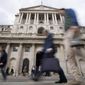 FILE - People pass the Bank of England in London, Wednesday, Sept. 28, 2022. On Tuesday, Oct. 11, 2022, The Bank of England expanded its efforts to stabilize the bond market to include inflation-linked bonds amid continuing concerns about the government’s budget.(AP Photo/Frank Augstein, File)