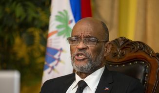 FILE - Haiti&#39;s Prime Minister Ariel Henry speaks during an interview with the Associated Press at his private residence in Port-au-Prince, Tuesday, Sept. 28, 2021. Henry and 18 top-ranking officials have requested on the second week of Oct. 2022, the immediate deployment of foreign armed troops as gangs and protesters paralyze the country. (AP Photo/Odelyn Joseph, File)