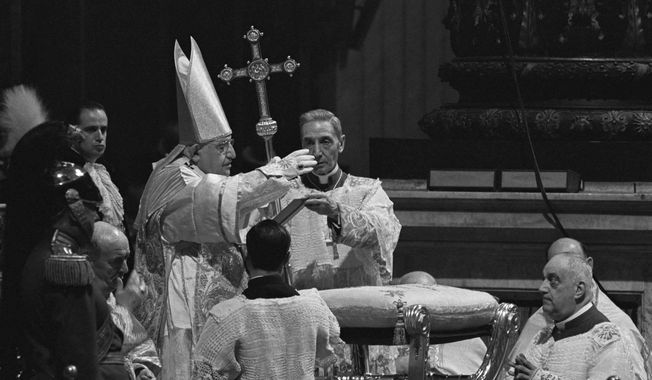 Pope John XXIII waves a hand in blessing at Roman Catholic Ecumenical Council at St. Peter&#x27;s Basilica in Vatican City, Oct. 11, 1962. Pope Francis commemorates the 60th anniversary of the opening of the Second Vatican Council by celebrating a Mass in honor of St. John XXIII, the “good pope” who convened the landmark meetings that modernized the Catholic Church. (AP Photo/Raoul Fornezza, File)