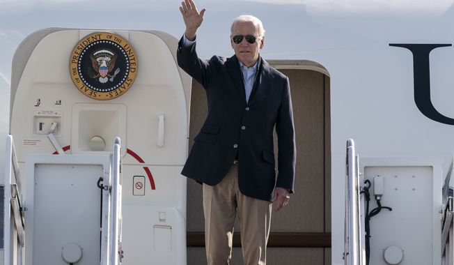 President Joe Biden waves as he boards Air Force One upon departure, Wednesday, Oct. 12, 2022, at Andrews Air Force Base, Md. Biden is en route to Colorado, California, Oregon, and returning to Delaware. (AP Photo/Alex Brandon)