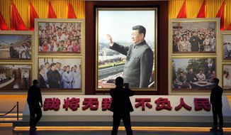 A portrait of Chinese President Xi Jinping is displayed near the words that means &quot;I will put aside my own well-being for the good of my People&quot; at the Museum of the Communist Party of China in Beijing, Wednesday, Oct. 12, 2022. (AP Photo/Ng Han Guan)