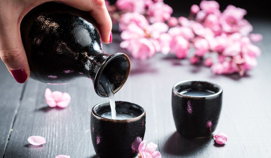 Sake with flowers of blooming cherry blossoms. (Image: Shutterstock/Shaiith)
