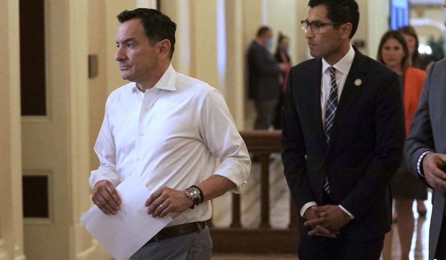 Assembly Speaker Anthony Rendon, left, of Lakewood, and Assemblyman Robert Rivas, D-Hollister, walk to a meeting of the Democratic caucus at the Capitol in Sacramento, Calif., Tuesday, May 31, 2022. Rendon said afterward that Rivas has the support of the majority of the Democratic caucus to be the next speaker into his final term. Lawmakers will sort out the issue after the new Legislature takes office Dec. 5. (AP Photo/Rich Pedroncelli, File)