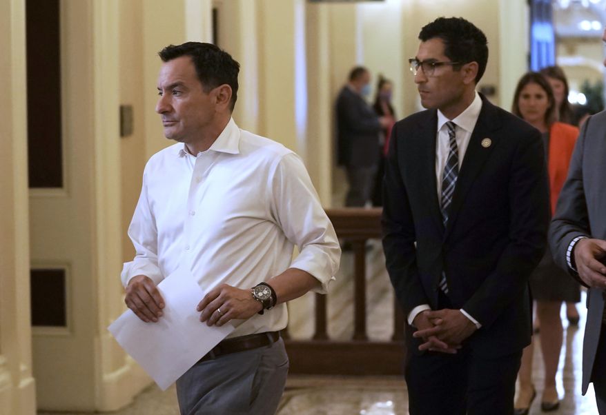 Assembly Speaker Anthony Rendon, left, of Lakewood, and Assemblyman Robert Rivas, D-Hollister, walk to a meeting of the Democratic caucus at the Capitol in Sacramento, Calif., Tuesday, May 31, 2022. Rendon said afterward that Rivas has the support of the majority of the Democratic caucus to be the next speaker into his final term. Lawmakers will sort out the issue after the new Legislature takes office Dec. 5. (AP Photo/Rich Pedroncelli, File)