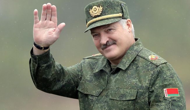 Belarusian President Alexander Lukashenko waves to the world cup journalists as he arrives at the Zapad (West) 2017 joint Russia-Belarus military exercises at the Borisovsky range in Borisov, Belarus, on Wednesday, Sept. 20, 2017. Lukashenko this week once again accused Ukraine of planning to attack it and announced creating a joint grouping of troops with Moscow, a move that stocked fears that Belarusian army could join Russian forces in Ukrainian trenches. (AP Photo, File)