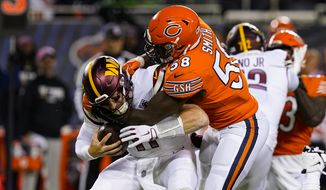 Washington Commanders quarterback Carson Wentz is sacked by Chicago Bears linebacker Roquan Smith in the first half of an NFL football game in Chicago, Thursday, Oct. 13, 2022. (AP Photo/Charles Rex Arbogast)