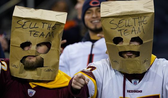 Washington Commanders fans in the stands before an NFL football game between the Washington Commanders and the Chicago Bears in Chicago, Thursday, Oct. 13, 2022. (AP Photo/Charles Rex Arbogast)