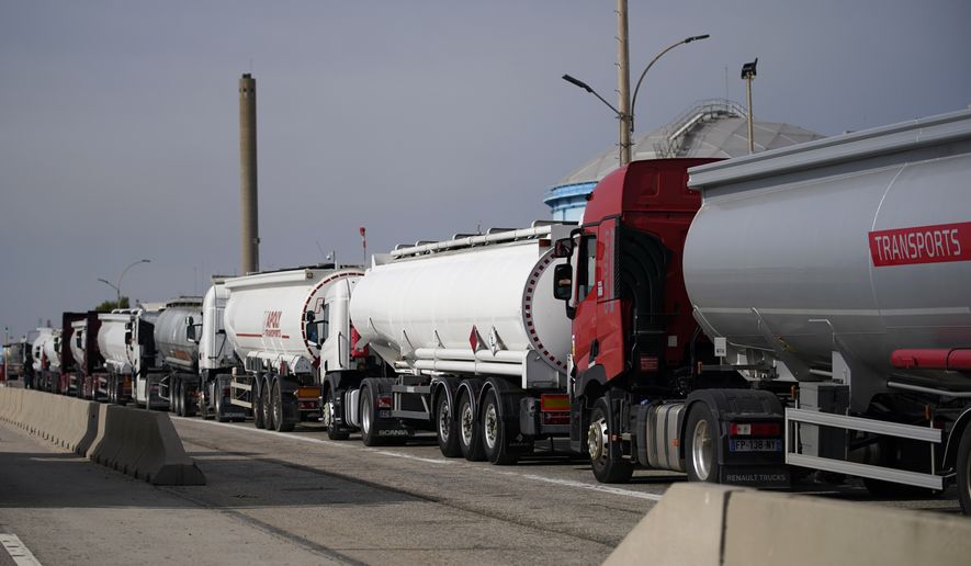 Tankers line up to refill Thursday, Oct. 13, 2022, in For-sur-Mer, southern France. French President Emmanuel Macron promised the situation in the country&#39;s gas stations will soon be back to &quot;normal&quot; as the government started requisitioning some workers at ExxonMobil&#39;s Esso gas stations amid an ongoing strike that is making life difficult for French drivers. (AP Photo/Daniel Cole)