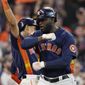 Houston Astros&#39; Yordan Alvarez, right, celebrates his two-run home run against the Seattle Mariners with teammates during the sixth inning in Game 2 of an American League Division Series baseball game in Houston, Thursday, Oct. 13, 2022. (AP Photo/David J. Phillip)