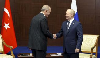 Russian President Vladimir Putin, right, and Turkey&#39;s President Recep Tayyip Erdogan shake hands during their meeting on sidelines of the Conference on Interaction and Confidence Building Measures in Asia (CICA) summit, in Astana, Kazakhstan, Thursday, Oct. 13, 2022. (Vyacheslav Prokofyev, Sputnik, Kremlin Pool Photo via AP)