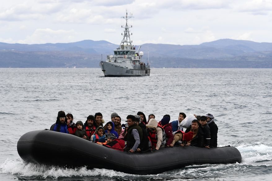 Migrants arrive with a dinghy accompanied by a Frontex vessel at the village of Skala Sikaminias, on the Greek island of Lesbos, after crossing the Aegean sea from Turkey, on Feb. 28, 2020. A much-anticipated report made public Thursday Oct. 13, 2022 by the European Union&#x27;s anti-fraud watchdog into the alleged involvement of the EU border agency Frontex in the illegal pushbacks of migrants from Greece to Turkey has concluded that agency employees were involved in covering up such incidents in violation of peoples&#x27; &amp;quot;fundamental rights.&amp;quot; (AP Photo/Michael Varaklas, File)
