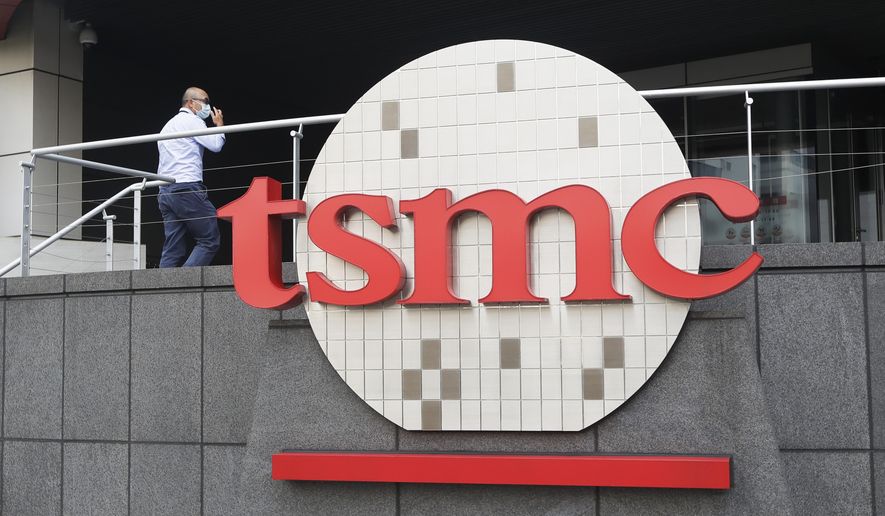 A person walks into the Taiwan Semiconductor Manufacturing Co., Ltd. (TSMC) headquarters in Hsinchu, Taiwan, on Oct. 20, 2021. (AP Photo/Chiang Ying-ying) **FILE**