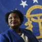 FILE - Democratic candidate for Georgia Governor Stacey Abrams poses for a portrait in front of the State Seal of Georgia on Aug. 8, 2022, in Decatur, Ga. The Georgia governor&#39;s race is a rematch of 2018, when Brian Kemp narrowly defeated Stacey Abrams. (AP Photo/John Bazemore, File)
