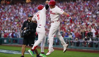 Philadelphia Phillies&#39; Rhys Hoskins (17) celebrates with Bryce Harper (3) after hitting a three-run home run during the third inning in Game 3 of baseball&#39;s National League Division Series against the Atlanta Braves, Friday, Oct. 14, 2022, in Philadelphia. (AP Photo/Matt Slocum)