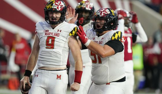Maryland quarterback Billy Edwards Jr. (9) celebrates with Coltin Deery (51) after running for a touchdown during the second half of an NCAA college football game against Indiana, Saturday, Oct. 15, 2022, in Bloomington, Ind. (AP Photo/Darron Cummings)