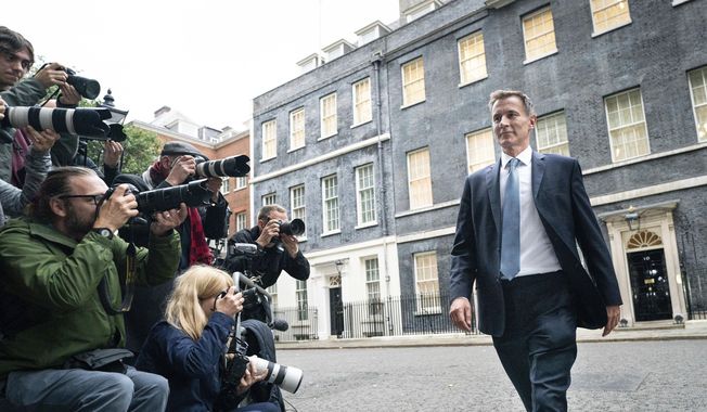 Jeremy Hunt leaves 10 Downing Street in London after he was appointed Chancellor of the Exchequer following the resignation of Kwasi Kwarteng, Friday, Oct. 14, 2022. Chancellor of the Exchequer Kwasi Kwarteng said he has accepted Prime Minister Liz Truss&#x27; request he &amp;quot;stand aside&amp;quot; as Chancellor, paying the price for the chaos unleashed by his mini-budget. (Stefan Rousseau/PA via AP)