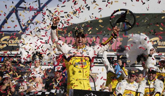Joey Logano celebrates after winning a NASCAR Cup Series auto race Sunday, Oct. 16, 2022, in Las Vegas. (AP Photo/John Locher)