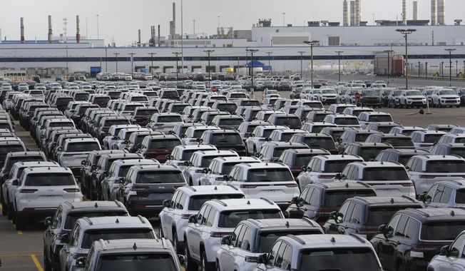 New vehicles are shown parked in storage lots near the the Stellantis Detroit Assembly Complex in Detroit, Wednesday, Oct. 5, 2022. Over the past few years, thieves have driven new vehicles from automaker storage lots and dealerships across the Detroit area. In 2018, eight vehicles were driven from what then was Fiat Chrysler&#x27;s Jefferson North plant. (AP Photo/Paul Sancya)