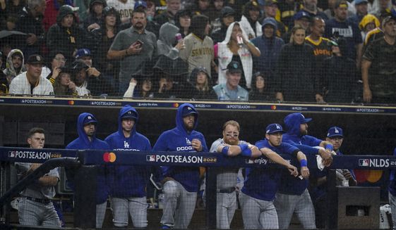 Members of the Los Angeles Dodgers look on from the dugout during the ninth inning in Game 4 of a baseball NL Division Series against the San Diego Padres, Saturday, Oct. 15, 2022, in San Diego. (AP Photo/Ashley Landis) **FILE**