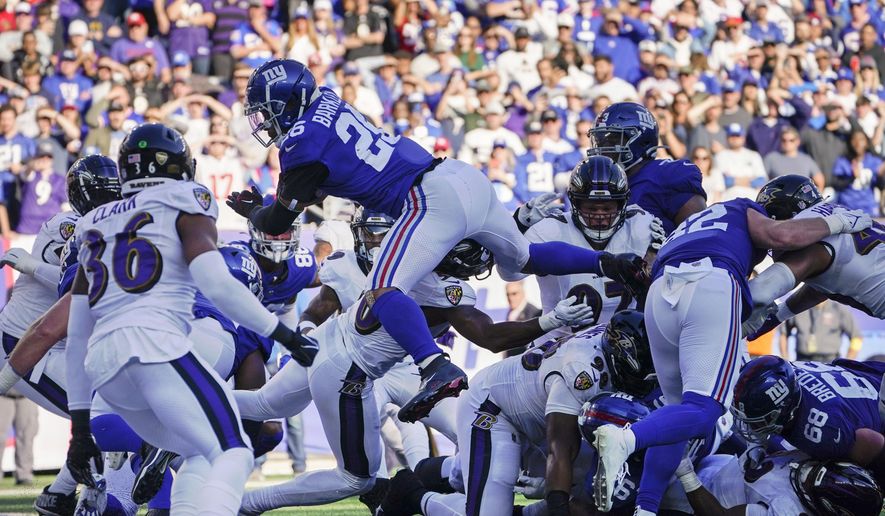New York Giants&#x27; Saquon Barkley (26) dives into the end zone for a touchdown during the second half of an NFL football game against the Baltimore Ravens, Sunday, Oct. 16, 2022, in East Rutherford, N.J. (AP Photo/John Minchillo)