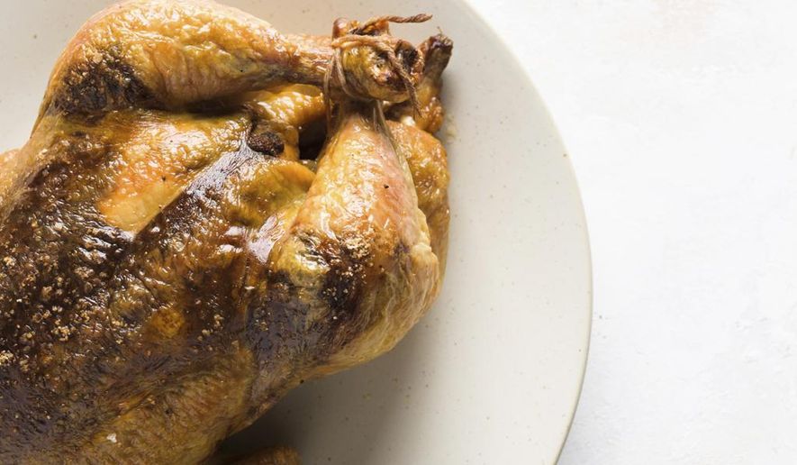This image released by Milk Street shows a recipe for Garam Masala + Tamarind Roasted Chicken. (Milk Street via AP)