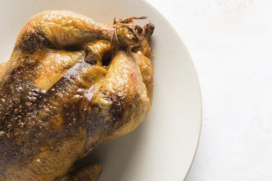 This image released by Milk Street shows a recipe for Garam Masala + Tamarind Roasted Chicken. (Milk Street via AP)