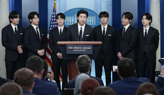 RM, center, accompanied by other K-pop supergroup BTS members from left, V, Jungkook, Jimin, Jin, J-Hope, and Suga speaks during the daily briefing at the White House in Washington, Tuesday, May 31, 2022. The members of K-pop band BTS will serve their mandatory military duties under South Korean law, their management company said Monday, Oct. 17, 2022, effectively ending a debate on exempting them because of their artistic accomplishments. (AP Photo/Evan Vucci, File)