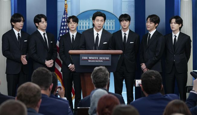 RM, center, accompanied by other K-pop supergroup BTS members from left, V, Jungkook, Jimin, Jin, J-Hope, and Suga speaks during the daily briefing at the White House in Washington, Tuesday, May 31, 2022. The members of K-pop band BTS will serve their mandatory military duties under South Korean law, their management company said Monday, Oct. 17, 2022, effectively ending a debate on exempting them because of their artistic accomplishments. (AP Photo/Evan Vucci, File)