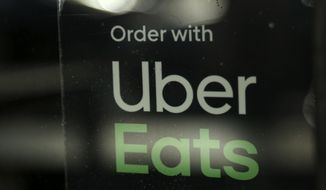 In this Nov. 6, 2019, file photo, a restaurant advertises Uber Eats in Miami. (AP Photo/Lynne Sladky, file)