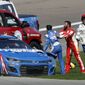 Bubba Wallace, center, shoves Kyle Larson (5), left, after they crashed during a NASCAR Cup Series auto race at Las Vegas Motor Speedway in Las Vegas, Sunday, Oct. 16, 2022. (Steve Marcus/Las Vegas Sun via AP) **FILE**
