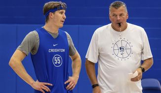 Creighton&#39;s Baylor Scheierman, left, talks with coach Greg McDermott during the NCAA college basketball team&#39;s practice Tuesday, Oct. 11, 2022, in Omaha, Neb. Scheierman is in his first year at Creighton after transferring from South Dakota State. (Chris Machian/Omaha World-Herald via AP) **FILE**