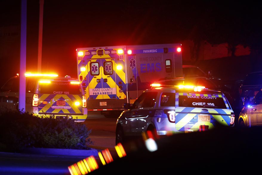 An ambulance believed to be carrying a shooting suspect arrives at Wake Medical Center Emergency Room in Raleigh, N.C., Thursday, Oct. 13, 2022, surrounded by police. North Carolina Democratic legislators pleaded with the General Assembly's Republican majority on Tuesday, Oct. 18, to consider gun safety and mental health measures, citing last week's shootings in Raleigh that left five people dead. (AP Photo/Karl DeBlaker, File)