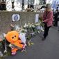A woman lays flowers outside the building where the body of 12-year-old schoolgirl was discovered in a trunk, in Paris, Wednesday, Oct. 19, 2022. France has been &amp;quot;profoundly shaken&amp;quot; by the murder of a 12-year-old schoolgirl, whose body was found in a plastic box, dumped in a courtyard of a building in northeastern Paris, the government spokesman Olivier Veran said on Wednesday. (AP Photo/Michel Euler)