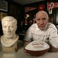 Pro Football Hall of Fame member Charley Trippi poses with memorabilia at his home in Athens, Ga., on Jan, 27, 2009. Trippi, a runner-up for the Heisman Trophy at Georgia who went on to lead the Cardinals to their most recent NFL championship in 1947, died Wednesday, Oct. 19, 2022. He was 100. (AP Photo/John Bazemore, File)