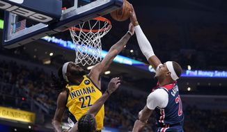 Washington Wizards&#39; Daniel Gafford shoots against Indiana Pacers&#39; Isaiah Jackson (22) during the first half of an NBA basketball game Wednesday, Oct. 19, 2022, in Indianapolis. (AP Photo/Michael Conroy)